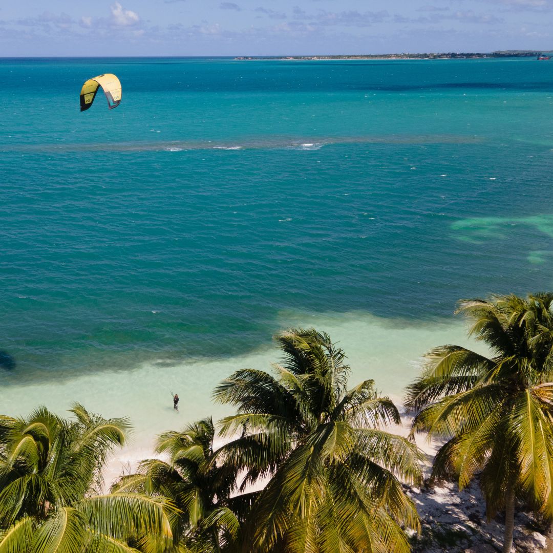 Kitesurfing lesson in Antigua with colorful kite over turquoise Caribbean water